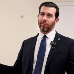 Socialist in Trump country gives Karl Marx vision thumbs-up before ducking key tax question